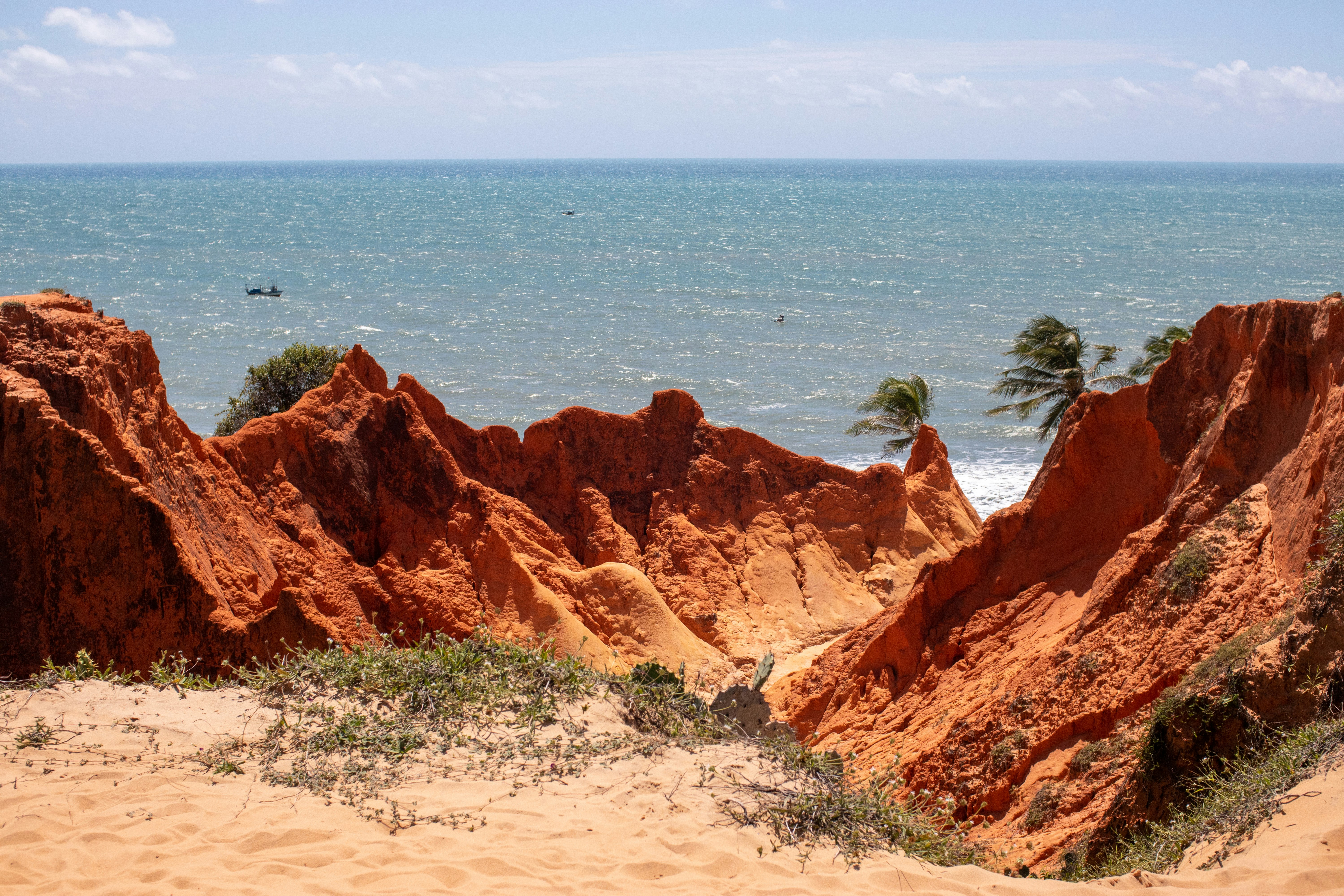 brown rock formation near body of water during daytime